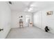 Empty bright bedroom featuring a ceiling fan, window, double door closet and carpeted floor at 5007 Kelso St, Leesburg, FL 34748