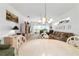 Open-concept dining area with views of the living room and outdoor scenery at 5007 Kelso St, Leesburg, FL 34748