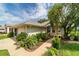 Inviting home exterior with landscaped front yard, featuring a variety of plants and a well-maintained lawn at 5007 Kelso St, Leesburg, FL 34748