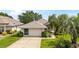 Charming single story home with a well-manicured lawn and 2 car garage at 5007 Kelso St, Leesburg, FL 34748
