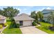 Charming single story home with a well-manicured lawn and 2 car garage at 5007 Kelso St, Leesburg, FL 34748