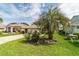 A well-manicured front yard with a stately palm tree and lush green grass at 5007 Kelso St, Leesburg, FL 34748