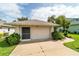 Exterior shot of garage highlighting a neatly maintained driveway, lawn, and well-maintained surroundings at 5007 Kelso St, Leesburg, FL 34748