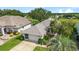 Beautiful home with a well-manicured lawn and driveway leading to the attached garage at 5007 Kelso St, Leesburg, FL 34748