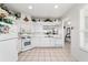 Functional kitchen featuring white appliances, tile floors, and an open concept design at 5007 Kelso St, Leesburg, FL 34748