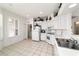 Bright kitchen features all-white appliances, tile flooring and ample counter space at 5007 Kelso St, Leesburg, FL 34748