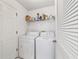 Functional laundry room with a washing machine, dryer, and storage shelves at 5007 Kelso St, Leesburg, FL 34748