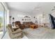 Spacious living room with a ceiling fan, comfortable seating, and an area rug at 5007 Kelso St, Leesburg, FL 34748