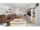 Bright living room featuring cozy seating, an entertainment center, and large windows at 5007 Kelso St, Leesburg, FL 34748