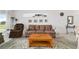 Cozy living room with a patterned sofa, recliner, and light blue patterned rug at 5007 Kelso St, Leesburg, FL 34748