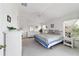 Sunlit main bedroom with white wicker furniture and a view of the outdoors at 5007 Kelso St, Leesburg, FL 34748
