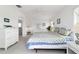Cozy main bedroom features a white dresser, bedside tables, and an ensuite bathroom at 5007 Kelso St, Leesburg, FL 34748