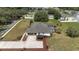 Aerial view showcasing the home with a pool, landscaping, and extended driveway at 5092 Ne 81St Blvd, Wildwood, FL 34785