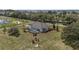 Aerial view showing the home with a pool, landscaping and views of the surrounding area at 5092 Ne 81St Blvd, Wildwood, FL 34785