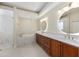 Beautiful bathroom features a soaking tub, glass shower, double vanity, and wooden cabinets at 5092 Ne 81St Blvd, Wildwood, FL 34785
