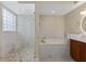 Beautiful bathroom features a soaking tub, glass shower, double vanity, and wooden cabinets at 5092 Ne 81St Blvd, Wildwood, FL 34785