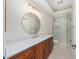 Beautifully designed bathroom featuring marble countertops, custom wood cabinets, and a glass walk-in shower at 5092 Ne 81St Blvd, Wildwood, FL 34785