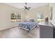 Comfortable bedroom with lots of natural light showcases neutral colors, decorative headboard, and charming decor at 5092 Ne 81St Blvd, Wildwood, FL 34785