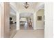 Inviting foyer with an open floor plan, archways, light hardwood floors, and views of the spacious living area at 5092 Ne 81St Blvd, Wildwood, FL 34785