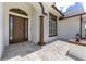 Elegant front door with decorative glass, a tile porch, and classic architectural details in a well-maintained home at 5092 Ne 81St Blvd, Wildwood, FL 34785