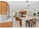 Open kitchen features stainless appliances, seating at the island, and wood cabinets at 5092 Ne 81St Blvd, Wildwood, FL 34785