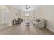 Bright living room with hardwood floors, a large bay window, neutral paint, and a comfortable seating arrangement at 5092 Ne 81St Blvd, Wildwood, FL 34785
