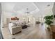 Open living area with tray ceiling connects kitchen, dining, and seating areas at 5092 Ne 81St Blvd, Wildwood, FL 34785