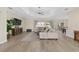 Bright living area boasts a tray ceiling, wood floors, and seamless access to dining area at 5092 Ne 81St Blvd, Wildwood, FL 34785