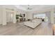 Open concept living room with wood floors flowing out to the lanai and pool at 5092 Ne 81St Blvd, Wildwood, FL 34785