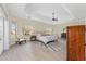 Spacious bedroom with tray ceilings, wood floors, neutral walls, and lots of natural light at 5092 Ne 81St Blvd, Wildwood, FL 34785