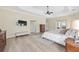 Spacious bedroom with tray ceilings, wood floors, neutral walls, and lots of natural light at 5092 Ne 81St Blvd, Wildwood, FL 34785