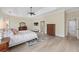 Spacious bedroom with tray ceilings, wood floors, neutral walls, and lots of natural light at 5092 Ne 81St Blvd, Wildwood, FL 34785