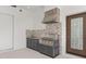 Stainless steel outdoor kitchen with built-in grill, sink, and a decorative backsplash at 5092 Ne 81St Blvd, Wildwood, FL 34785