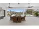 Relaxing outdoor patio with a dining area overlooking a screened pool and lush greenery, perfect for entertaining at 5092 Ne 81St Blvd, Wildwood, FL 34785