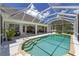 Beautiful backyard with a screened in pool, outdoor seating, and a complete outdoor kitchen at 5092 Ne 81St Blvd, Wildwood, FL 34785