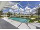 The backyard features a screened in pool with a brick trim and manicured landscaping at 5092 Ne 81St Blvd, Wildwood, FL 34785
