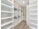Spacious walk-in closet features custom shelving with a modern design and open storage for maximum organization at 5092 Ne 81St Blvd, Wildwood, FL 34785