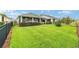 Wide backyard view highlighting the covered patio and landscaping, perfect for relaxation and recreation at 5651 Nw 40Th Pl, Ocala, FL 34482