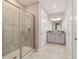 Bathroom boasts a double vanity, stone floors, and a glass shower enclosure at 5651 Nw 40Th Pl, Ocala, FL 34482