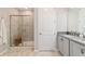 Bathroom features a walk-in shower with glass doors, stone-look tile, and bench seating at 5651 Nw 40Th Pl, Ocala, FL 34482