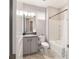Bathroom with gray vanity, tiled floor, and shower-tub combination at 5651 Nw 40Th Pl, Ocala, FL 34482