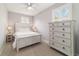 Bedroom with wood-look dresser, shuttered windows, ceiling fan, and carpet at 5651 Nw 40Th Pl, Ocala, FL 34482