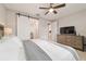Bedroom features wood furnishings, a ceiling fan, and an ensuite bathroom behind a barn door at 5651 Nw 40Th Pl, Ocala, FL 34482