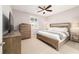 Bedroom with wood furnishings, a ceiling fan, and a view to the outside through shuttered windows at 5651 Nw 40Th Pl, Ocala, FL 34482
