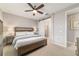 Bedroom features wood furnishings, a ceiling fan, and an ensuite bathroom behind a barn door at 5651 Nw 40Th Pl, Ocala, FL 34482