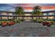 Elegant building exterior with a large courtyard and seating areas, surrounded by lush landscaping at 5651 Nw 40Th Pl, Ocala, FL 34482