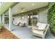 Cozy covered patio with comfortable rocking chairs and easy access to the home's interior at 5651 Nw 40Th Pl, Ocala, FL 34482