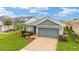 Charming single-story home with a brick driveway, well-manicured landscaping, and a two-car garage at 5651 Nw 40Th Pl, Ocala, FL 34482