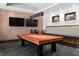 A game room inside the clubhouse with a pool table, couch and mounted televisions on the wall at 5651 Nw 40Th Pl, Ocala, FL 34482