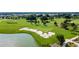 Scenic golf course featuring a pristine lake and meticulously maintained sand traps on a sunny day at 5651 Nw 40Th Pl, Ocala, FL 34482